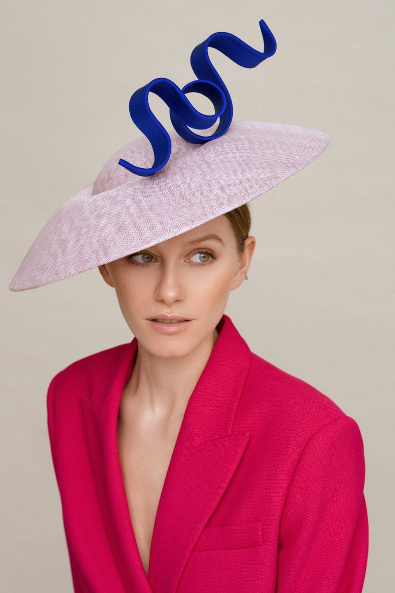 Woman wearing a lilac saucer hat with blue trimming